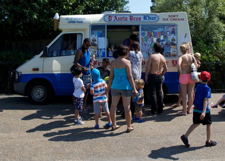 Customers line up near an ice cream truck