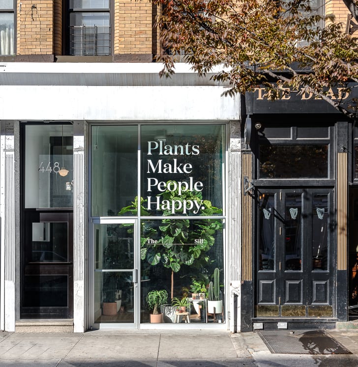 The exterior of The Sill's Amsterdam Avenue location, which reads "Plants Make People Happy."
