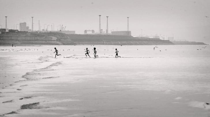 Kids pass away the time during the summer school holidays on the beach at Portobello on July 29, 2004 in Edinburgh, Scotland