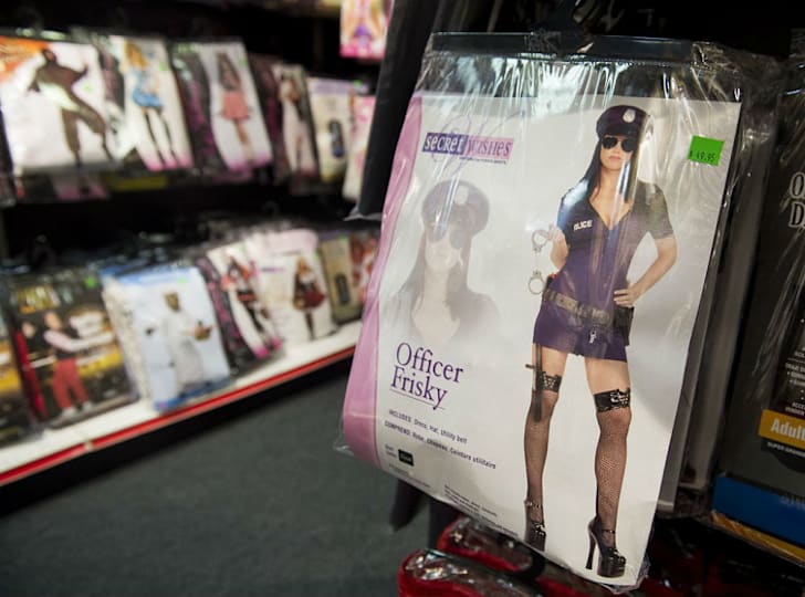 A packaged Halloween costume hangs on a store rack