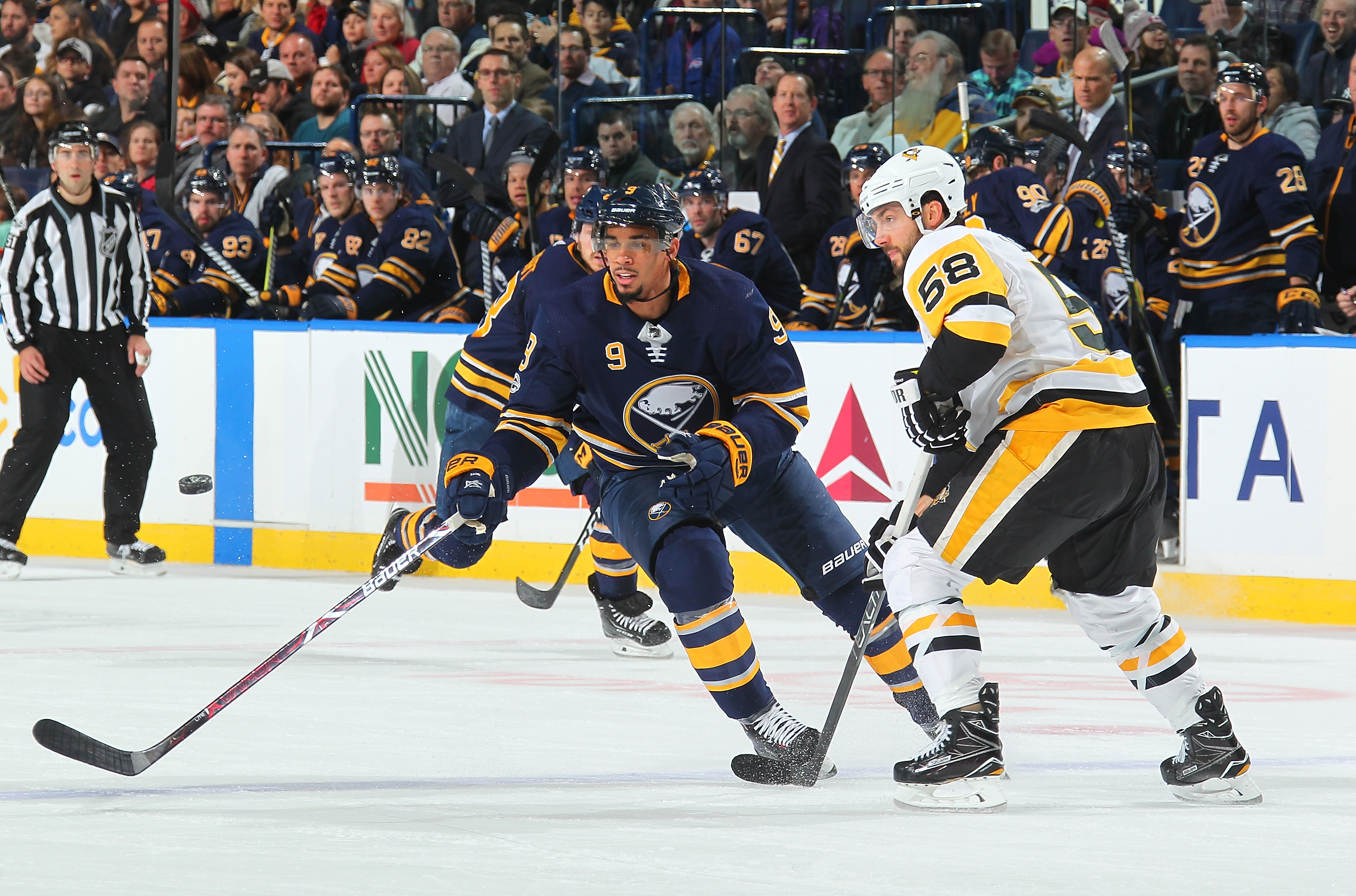 Jason Pominville of the Buffalo Sabres skates past Sidney Crosby of News  Photo - Getty Images
