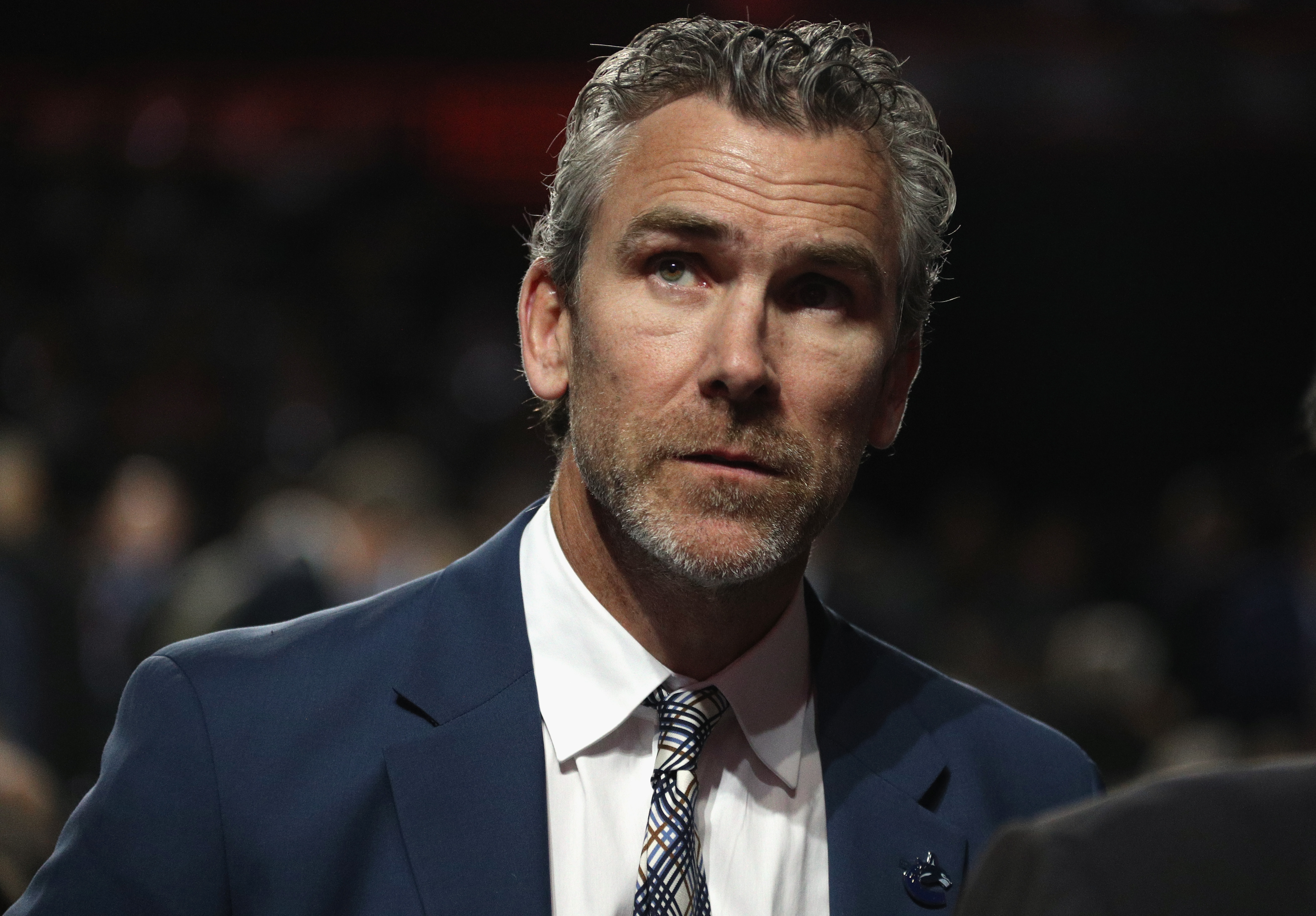Vancouver Canucks' Trevor Linden, left, is followed by his wife