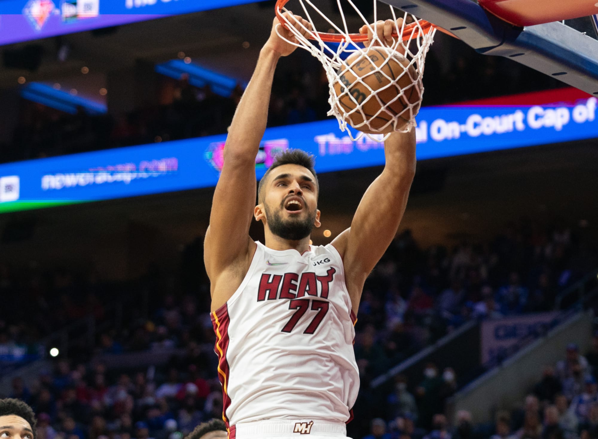 Miami Heat's Omer Yurtseven, right, get the rebound ahead of