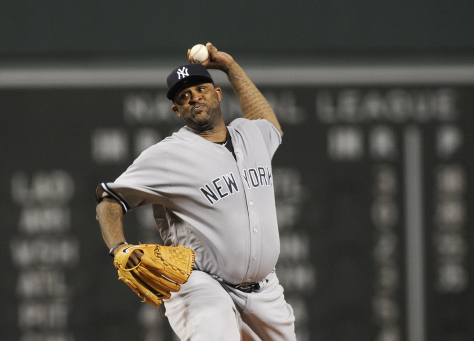 New York Yankees starting pitcher CC Sabathia wipes his face on