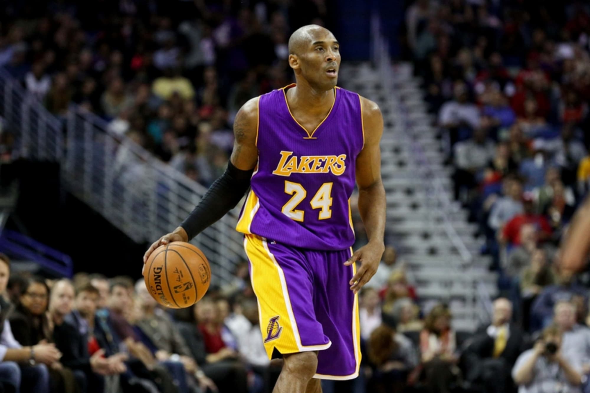 FILE: Kobe Bryant of the Los Angeles Lakers flexes his bicep as he dribbles  the ball down court during a National Basketball Association game at the  Great Western Forum in Los Angeles