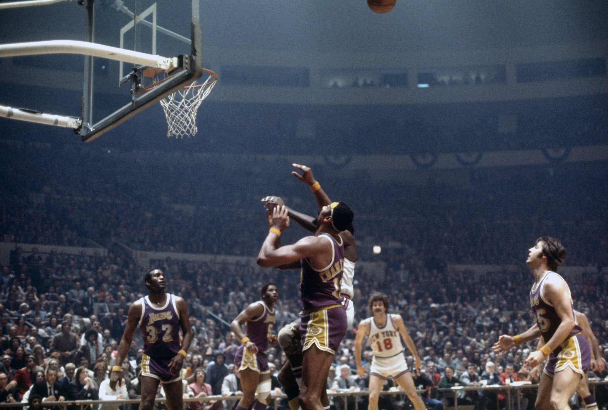 Wilt Chamberlain of the Los Angeles Lakers winds up to throw basketball the  length of the court to a teammate for a easy two points in game with the  Portland Trail Blazers