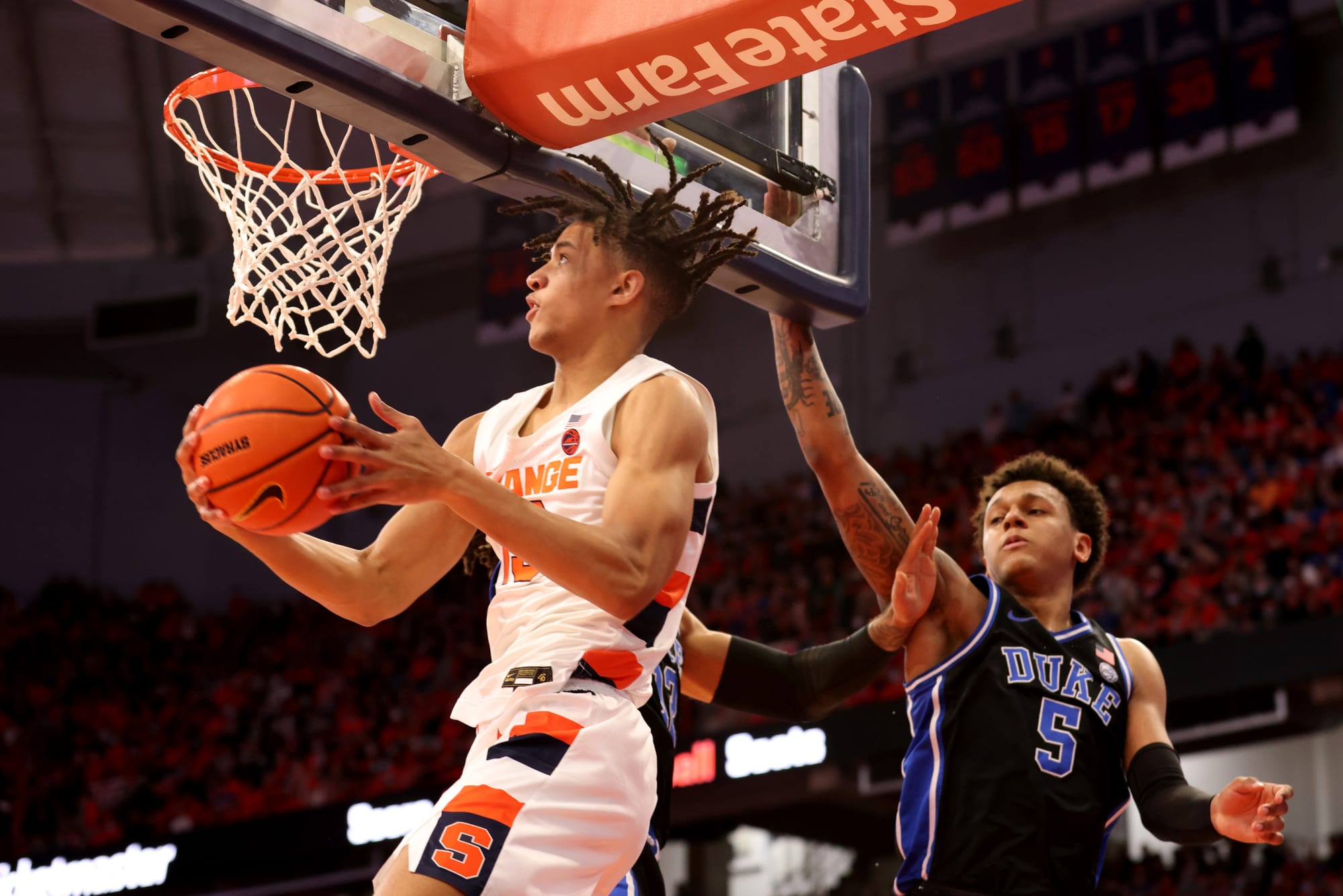 Syracuse forward Benny Williams, right, grabs a rebound in front