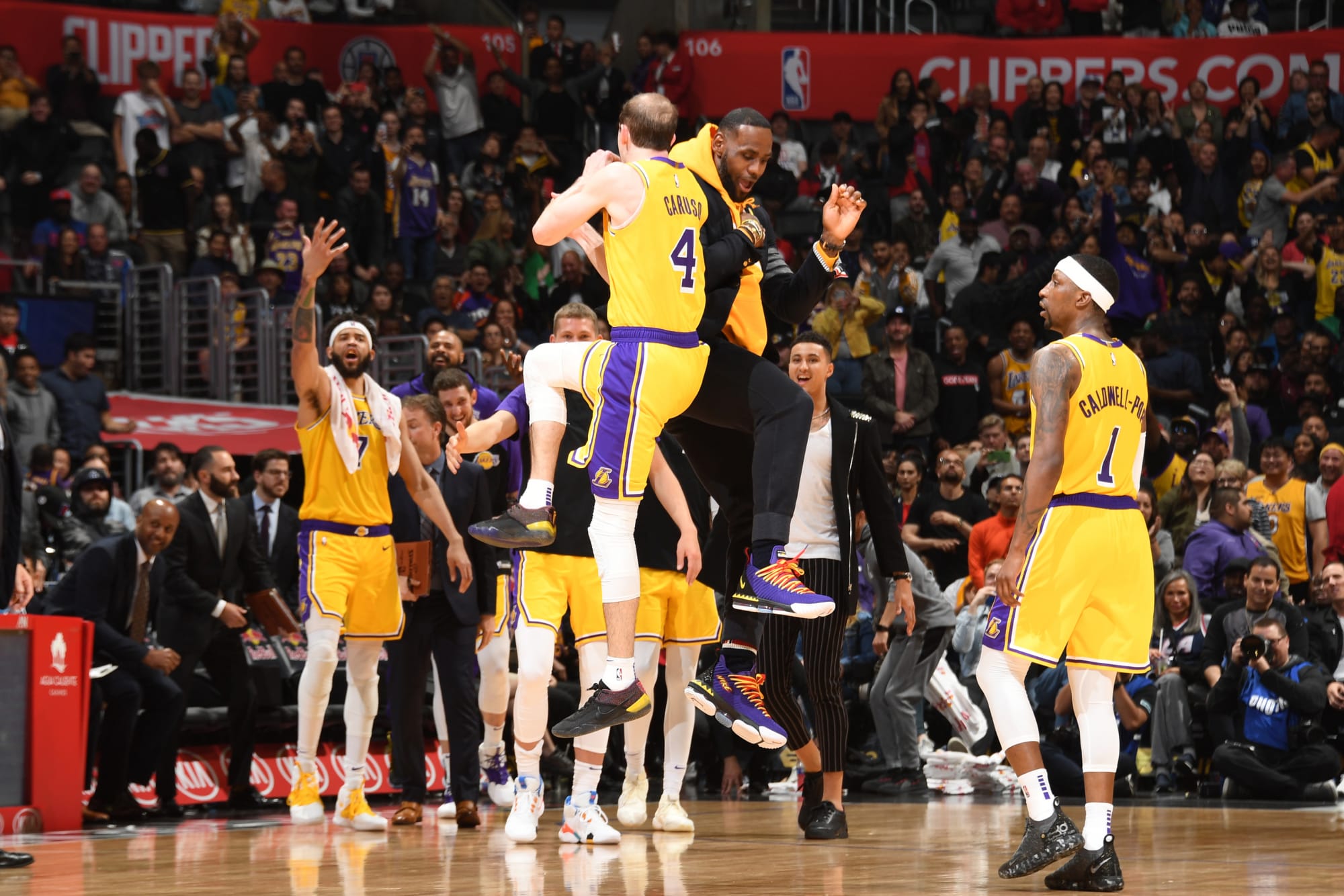 Los Angeles Lakers guard Alex Caruso, left, dunks as Los Angeles Lakers  center Dwight Howard, second from right, and forward LeBron James, right,  also approach the basket while Detroit Pistons guard Sviatoslav