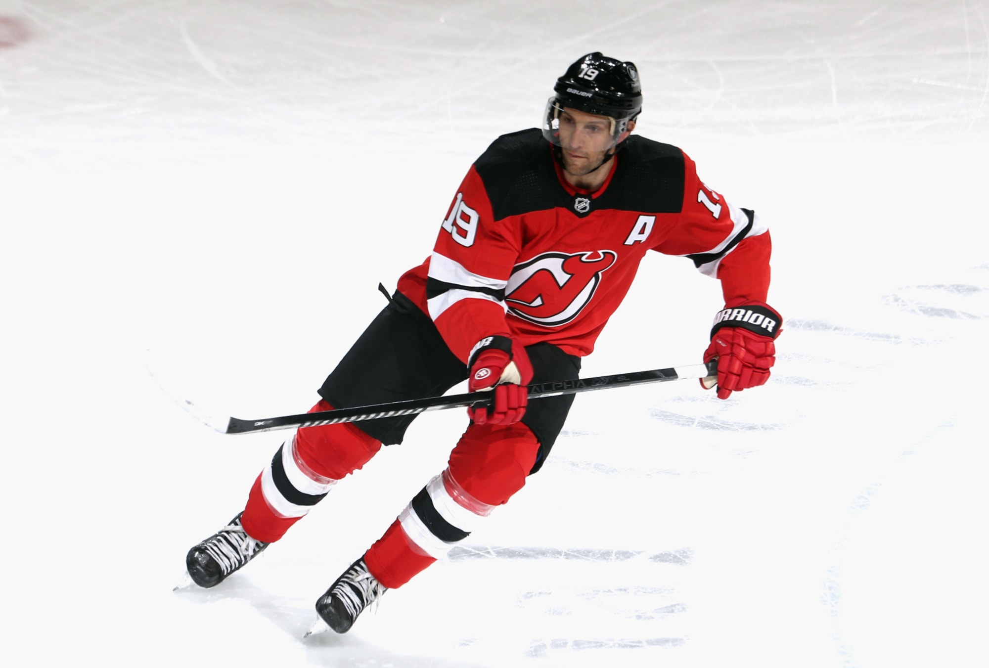 New Jersey Devils center Travis Zajac (19) checks Ottawa Senators