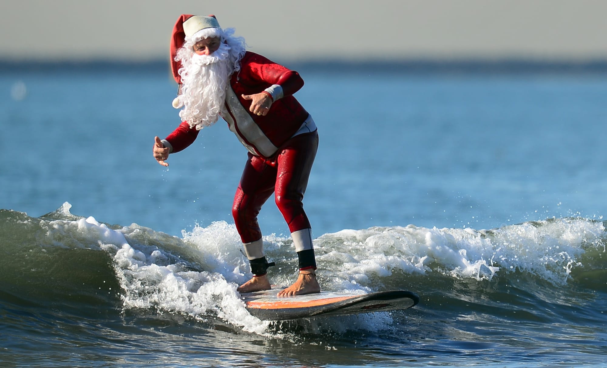 Surfing Santas at Cocoa Beach Santa Rides The Waves On Christmas