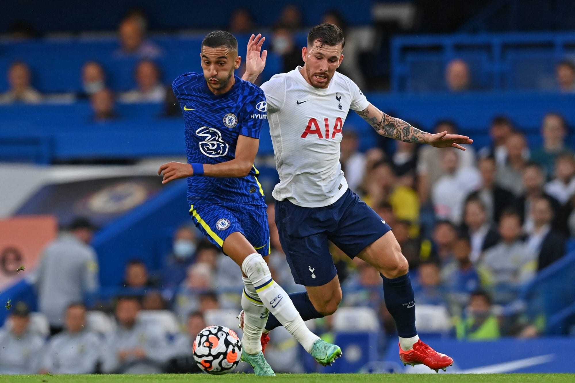  Hakim Ziyech of Chelsea and Pierre-Emile Hojbjerg of Tottenham Hotspur compete for the ball during the Premier League match between Chelsea and Tottenham Hotspur at Stamford Bridge.