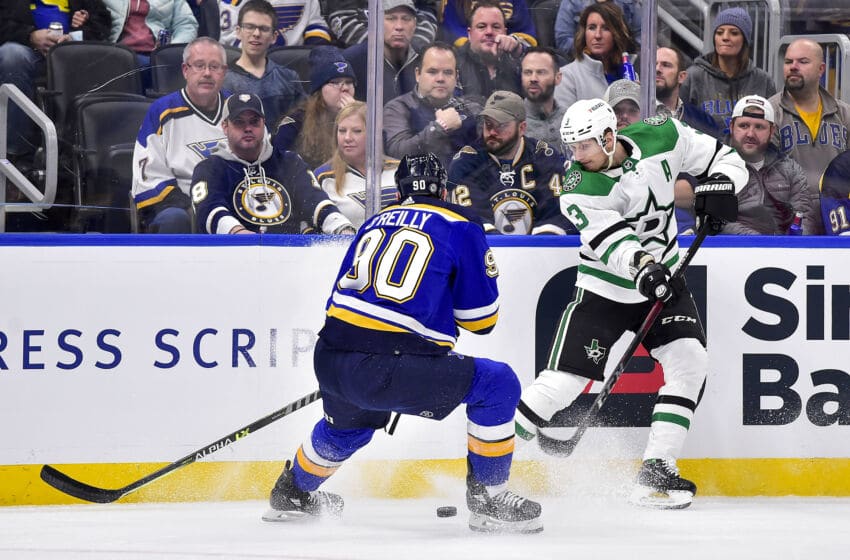 Dec 17, 2021; St. Louis, Missouri, USA; Dallas Stars defenseman John Klingberg (3) passes the puck as St. Louis Blues center Ryan O'Reilly (90) defends during the first period at Enterprise Center. Mandatory Credit: Jeff Curry-USA TODAY Sports