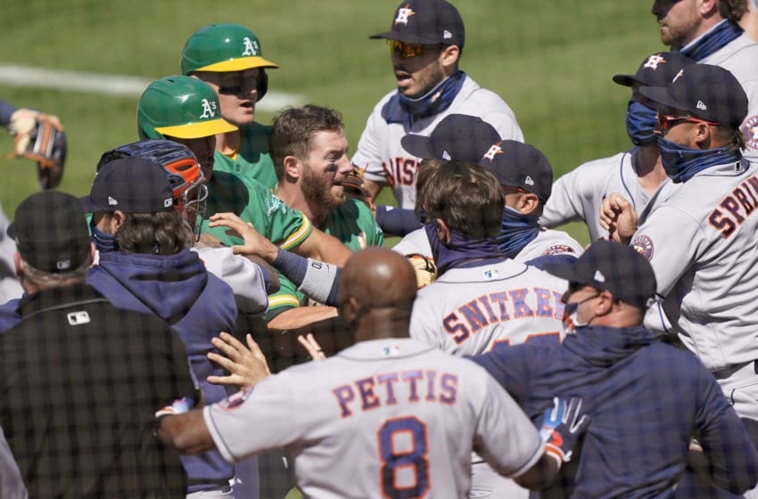 OAKLAND, CALIFORNIA - AUGUST 09: Players from the Houston Astros and Oakland Athletics get into a shoving match after Ramon Laureano #22 of the Athletics was hit by a pitch and charged into the Astros dugout in the bottom of the seventh inning at RingCentral Coliseum on August 09, 2020 in Oakland, California. (Photo by Thearon W. Henderson/Getty Images)