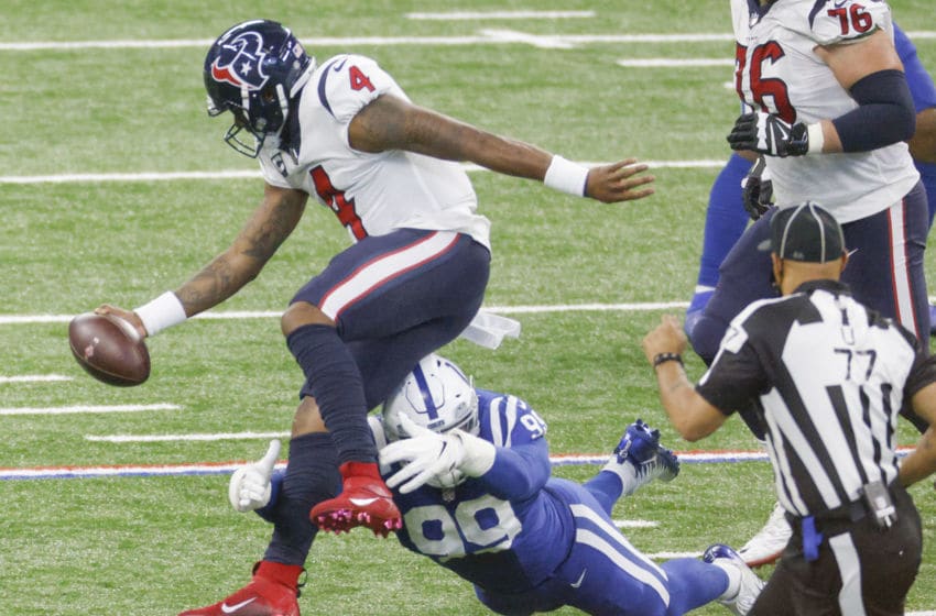 INDIANAPOLIS, IN - DECEMBER 20: Deshaun Watson #4 of the Houston Texans tries to leaps to evade the tackle from DeForest Buckner #99 of the Indianapolis Colts during the second half at Lucas Oil Stadium on December 20, 2020 in Indianapolis, Indiana. (Photo by Michael Hickey/Getty Images)