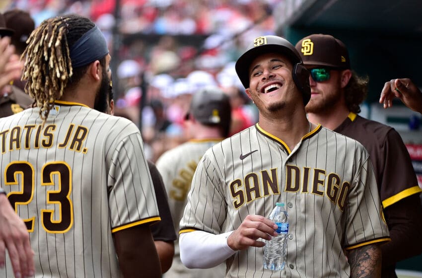 Sep 19, 2021; St. Louis, Missouri, USA; San Diego Padres third baseman Manny Machado (13) jokes around with center fielder Fernando Tatis Jr. (23) after scoring from first base during the eighth inning against the St. Louis Cardinals at Busch Stadium. Mandatory Credit: Jeff Curry-USA TODAY Sports