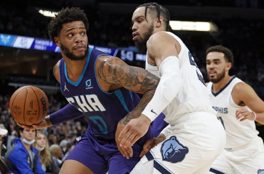 Nov 10, 2021; Memphis, Tennessee, USA; Charlotte Hornets forward Miles Bridges (0) dribbles as Memphis Grizzles guard Dillon Brooks (24) defends during the first half at FedExForum. Mandatory Credit: Petre Thomas-USA TODAY Sports