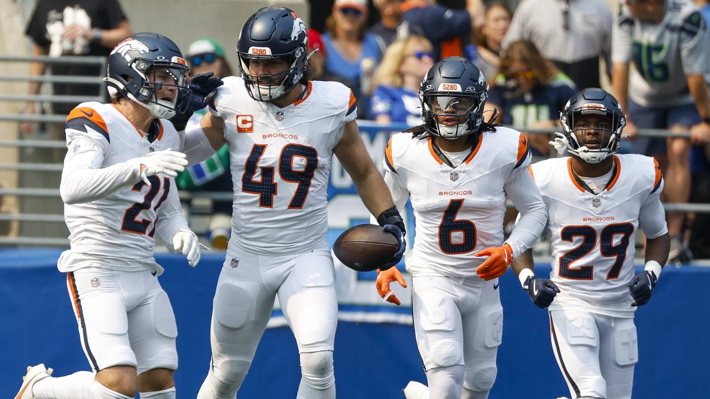 Broncos defense celebrates a turnover Denver Broncos defenders celebrate a turnover during NFL game action