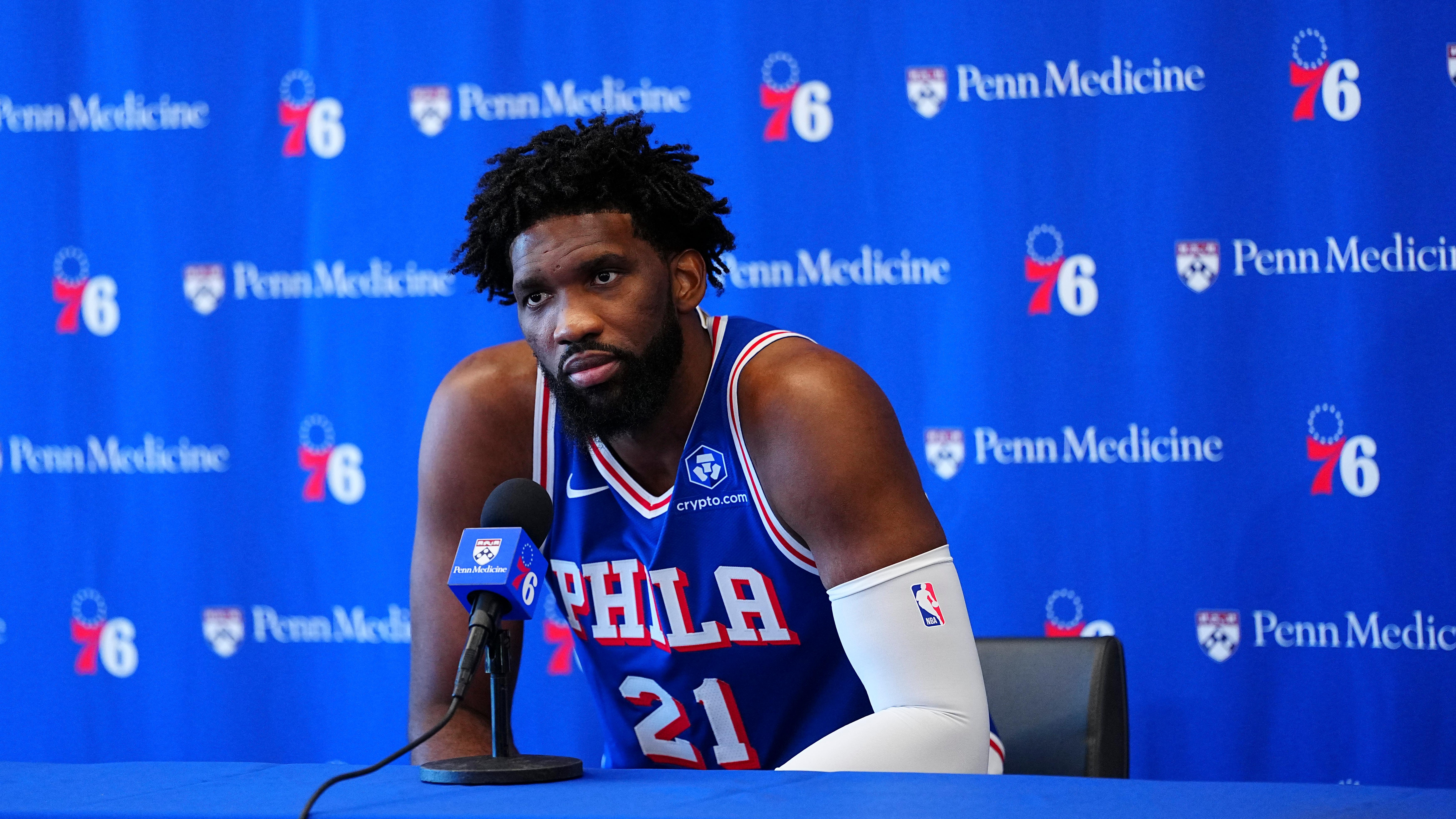 Joel Embiid speaking in a Philadelphia 76ers jersey