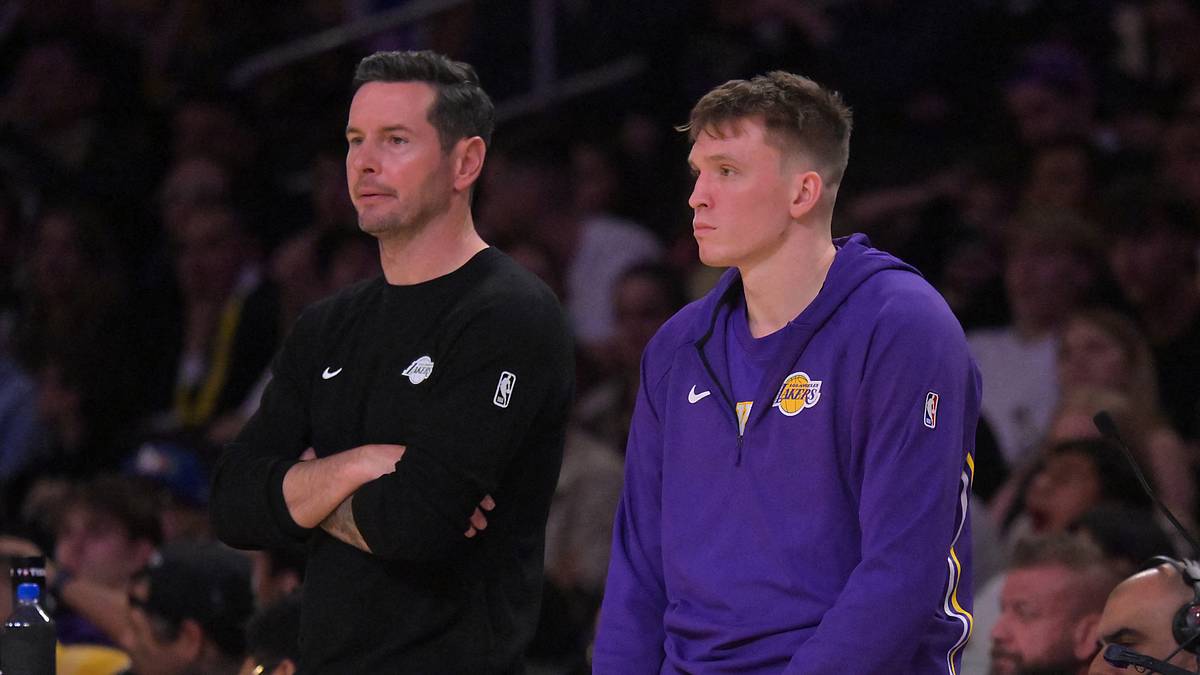 Lakers coach JJ Redick stands beside Dalton Knecht during a March 2026 game