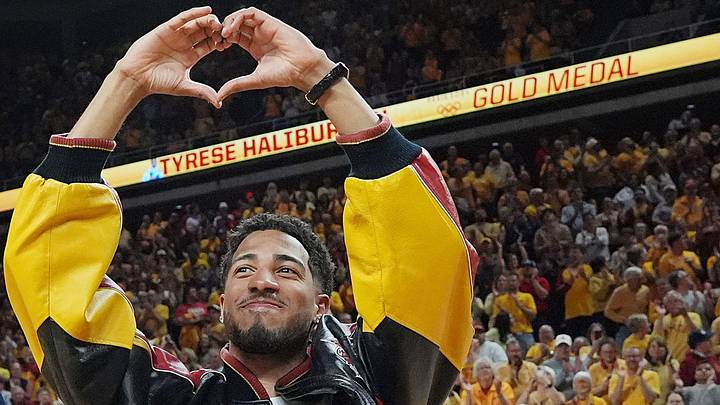 Tyrese Haliburton makes a heart gesture during his Olympic gold medal banner ceremony at Iowa State's Hilton Coliseum