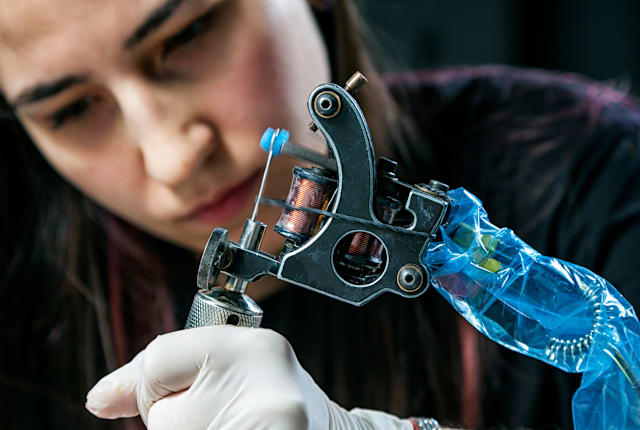 A professional tattoo artist at work