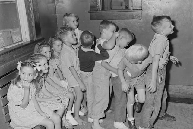 Preschoolers waiting to be vaccinated for smallpox outside their doctor's office.