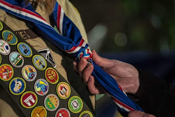 A new scout receiving her Eagle Scout neckerchief at a regional ceremony in Tacoma, Washington.