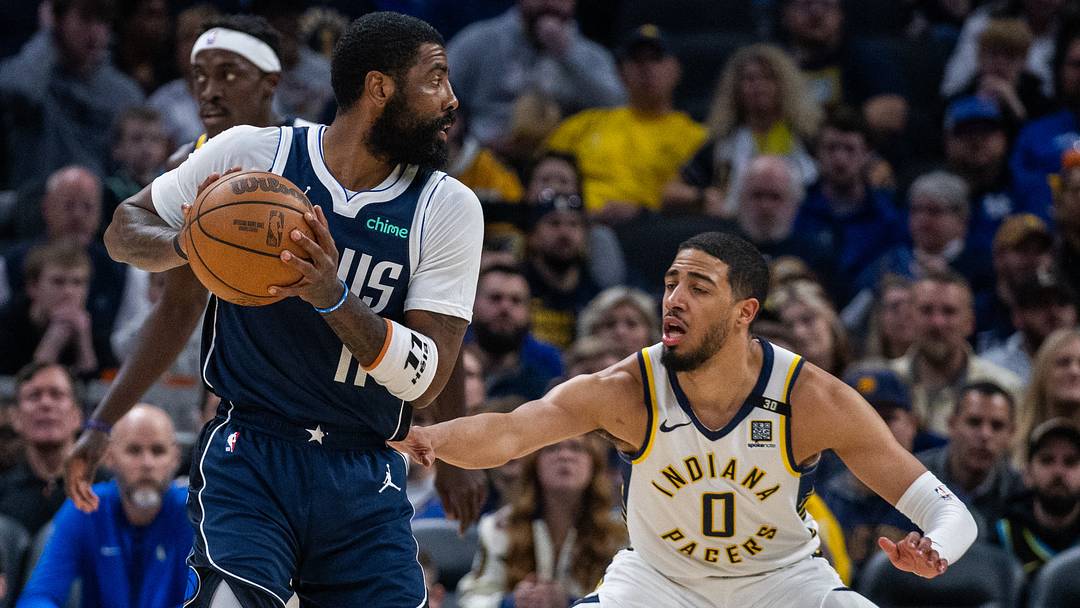 Feb 25, 2024; Indianapolis, Indiana, USA; Dallas Mavericks guard Kyrie Irving (11) holds the ball while Indiana Pacers guard Tyrese Haliburton (0) defends in the first half at Gainbridge Fieldhouse. Mandatory Credit: Trevor Ruszkowski-USA TODAY Sports