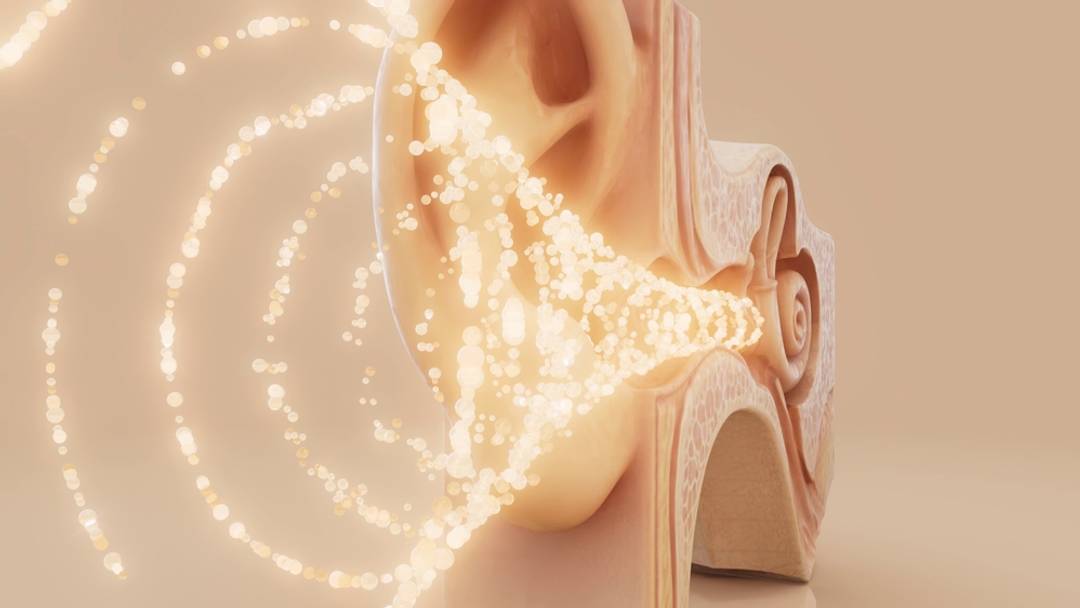 Golden circles of light moving into ear Golden circles of light moving into ear
