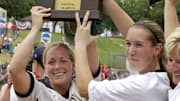 Jocelyn Forest, left, and Candace Harper hoist championship trophy