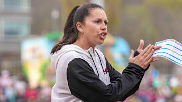 Arkansas Razorbacks softball coach Courtney Deifel clapping during the team's at-bat against the Kentucky Wildcats at Bogle Park in Fayetteville, Ark.