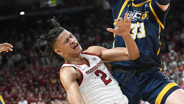 Razorbacks Forward Trevon Brazile Grimaces after a knee injury against UNC-Greensboro goes down