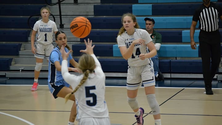 Seven Rivers Christian's Annalise de Beer passes the ball to Johnnie Spaulding during the Region 1A-1 quarterfinal on Feb. 6, 2025 against visiting St. Johns Country Day.