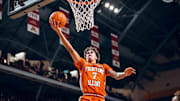 Illinois forward Will Riley (7) floats in a layup on his way to a game-high 27 points in the Illini's 95-74 win over Minnesota on Saturday at Williams Arena in Minneapolis.