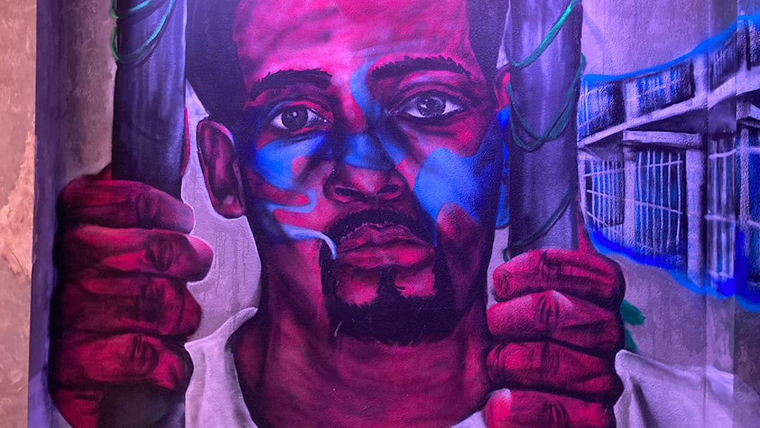 A mural by artists Maya Sanders and Distort, reflecting the unjust ways anti-cannabis laws have been used to target Black and Brown communities. A mural by artists Maya Sanders and Distort, reflecting the unjust ways anti-cannabis laws have been used to target Black and Brown communities.
