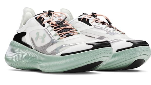 Side view of green Under Armour sneakers.