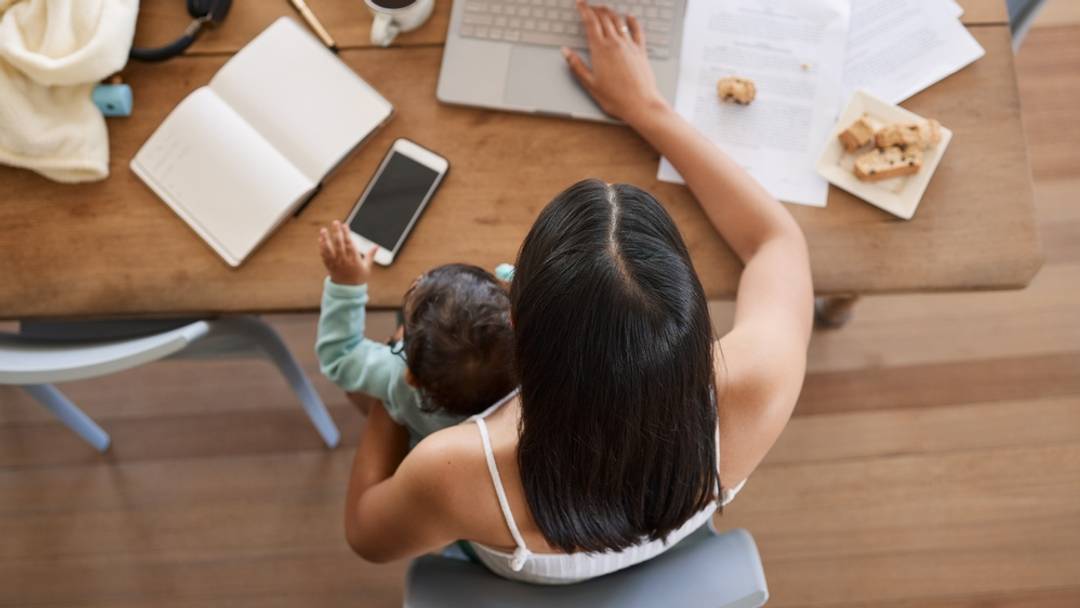 Mom with baby working at table