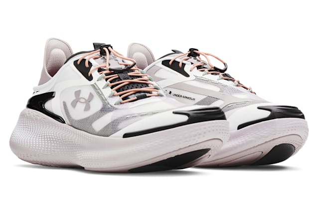 Side view of gray Under Armour sneakers.