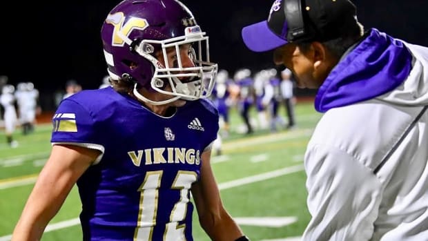 Coach Tom Tri had a sideline meeting with quarterback Kolton Matson during WIAA championship game in Tacoma.