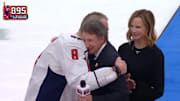 Alex Ovechkin hugs Wayne Gretzky after surpassing his longstanding NHL goals record.