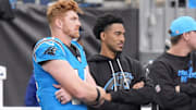 Oct 26, 2025; Charlotte, North Carolina, USA; Carolina Panthers quarterback Andy Dalton (14) and quarterback Bryce Young (9) on the sideline during the second half against the Buffalo Bills at Bank of America Stadium. 