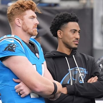Oct 26, 2025; Charlotte, North Carolina, USA; Carolina Panthers quarterback Andy Dalton (14) and quarterback Bryce Young (9) on the sideline during the second half against the Buffalo Bills at Bank of America Stadium. 