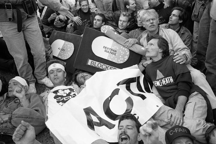 Black and white photo of ACT UP members staging an AIDS protest at the FDA building in Rockville, Maryland, in 1988.