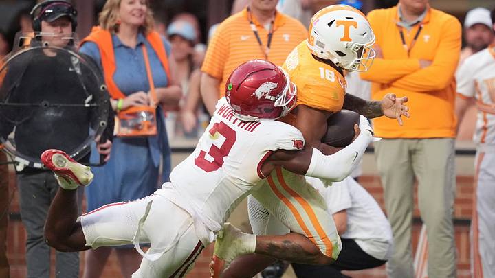 Tennessee running back DeSean Bishop (18) is tackled by Arkansas defensive back Larry Worth III (3) during a college football game between Tennessee and Arkansas at Neyland Stadium in Knoxville, Tennessee on Oct. 11, 2025.