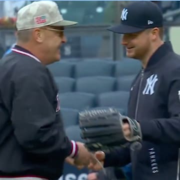New York Yankees SP Clarke Schmidt and his father Dwight Schmidt embrace after Dwight threw out the ceremonial first pitch at Yankee Stadium.