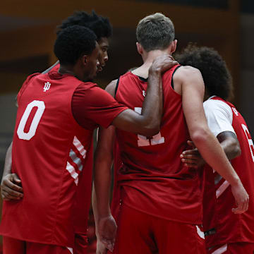 Indiana basketball guard Jasai Miles (0) huddles around forward Trent Sisley (11) during an exhibition game Aug. 6, 2025.