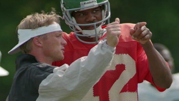Philadelphia Eagles QB Randall Cunningham and offensive coordinator Jon Gruden talk strategy during training camp on July 26,