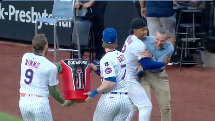 Brandon Nimmo and Brett Baty empty a cooler onto Francisco Lindor, who is holding onto SNY's New York Mets reporter Steve Gelbs. Brandon Nimmo and Brett Baty empty a cooler onto Francisco Lindor, who is holding onto SNY's New York Mets reporter Steve Gelbs.