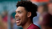 Florida State infielder Cam Smith (24) looks on from the dugout in-between the second and third innings of an NCAA baseball matchup at 121 Financial Ballpark in Jacksonville, Fla. Florida State defeated Florida 14-3
