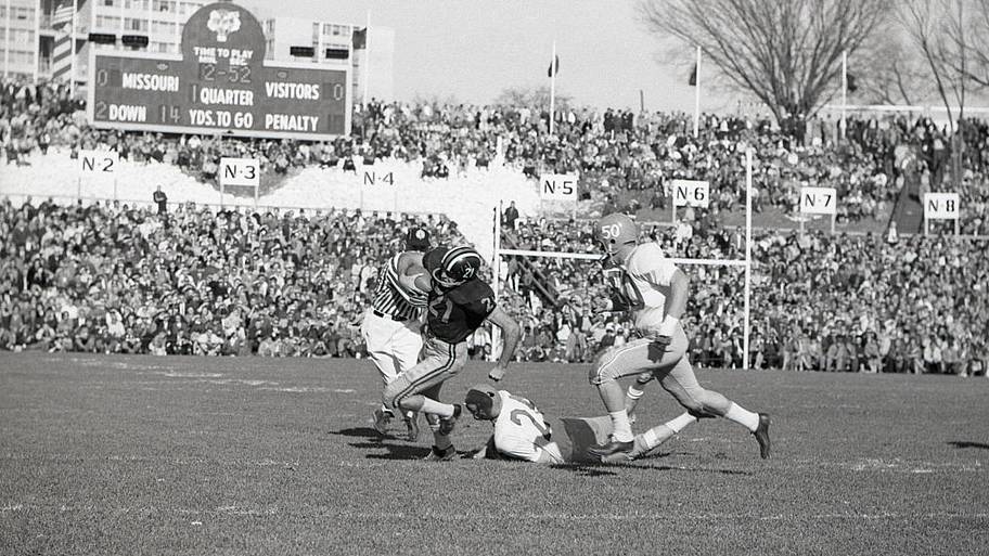 Missouri halfback Norman Beal was fast enough to lose Kansas was knocked down by Kansas center Kent Staab.